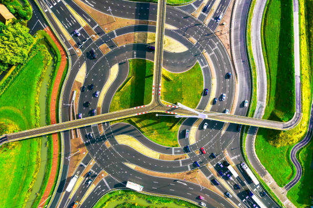 Drone picture taken directly above of the Snelbinder traffic circle called turbo roundabout. It's a complex traffic circulation system, where every line takes to specific roundabout exit, also there is a suspended bicycle path system with cool shape. Netherlands.